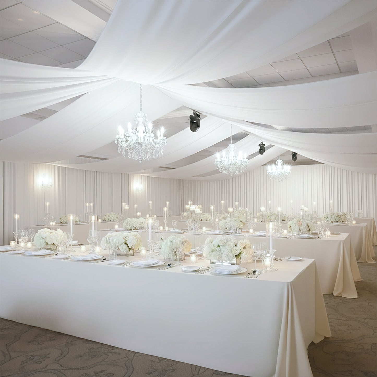 White 4-way stretch spandex event curtain drapes in a beautifully decorated venue.