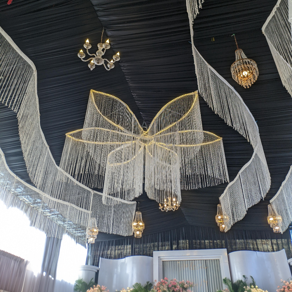 Black stretch spandex tent ceiling drape with elegant decor and lighting.
