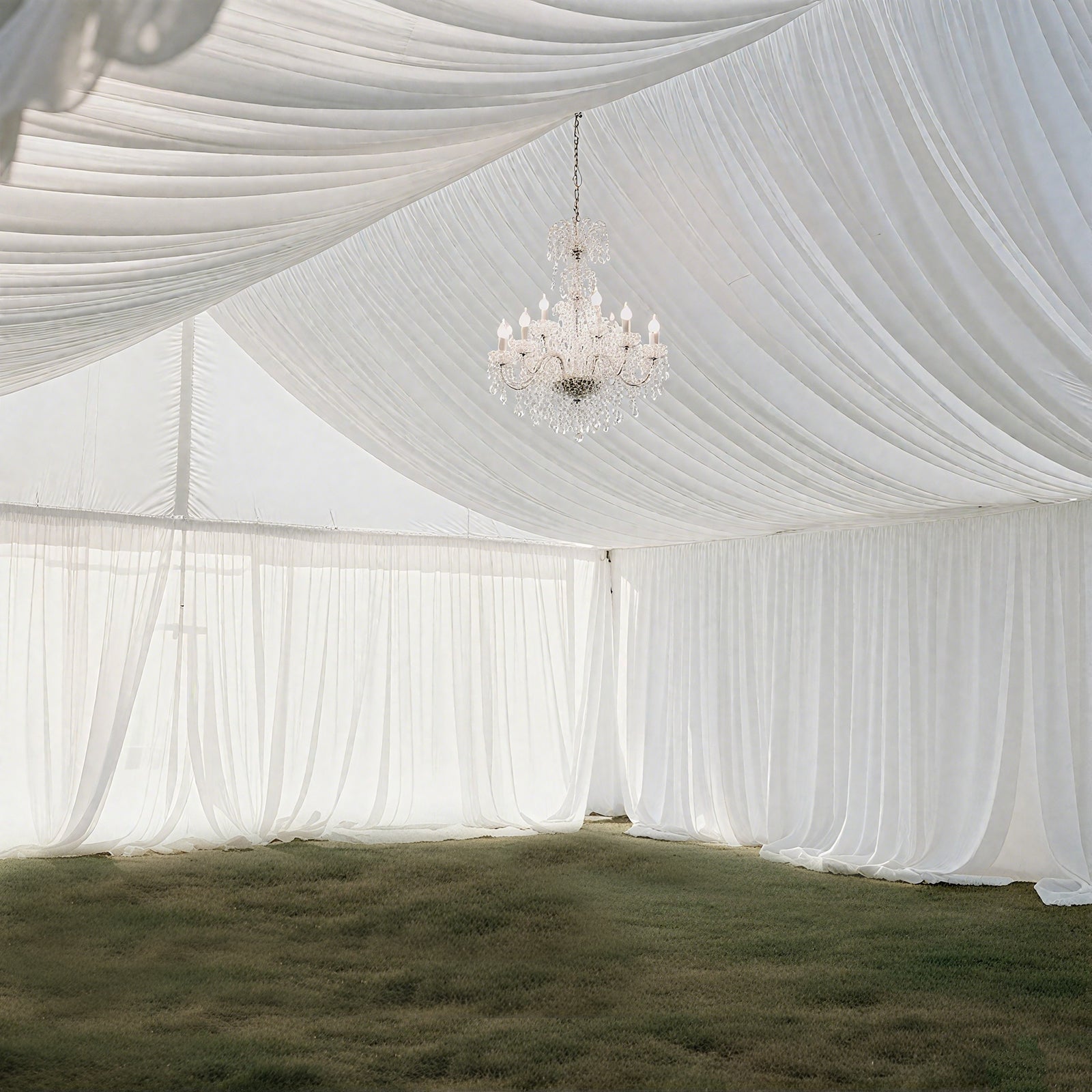 White stretch spandex tent ceiling drape with elegant chandelier.