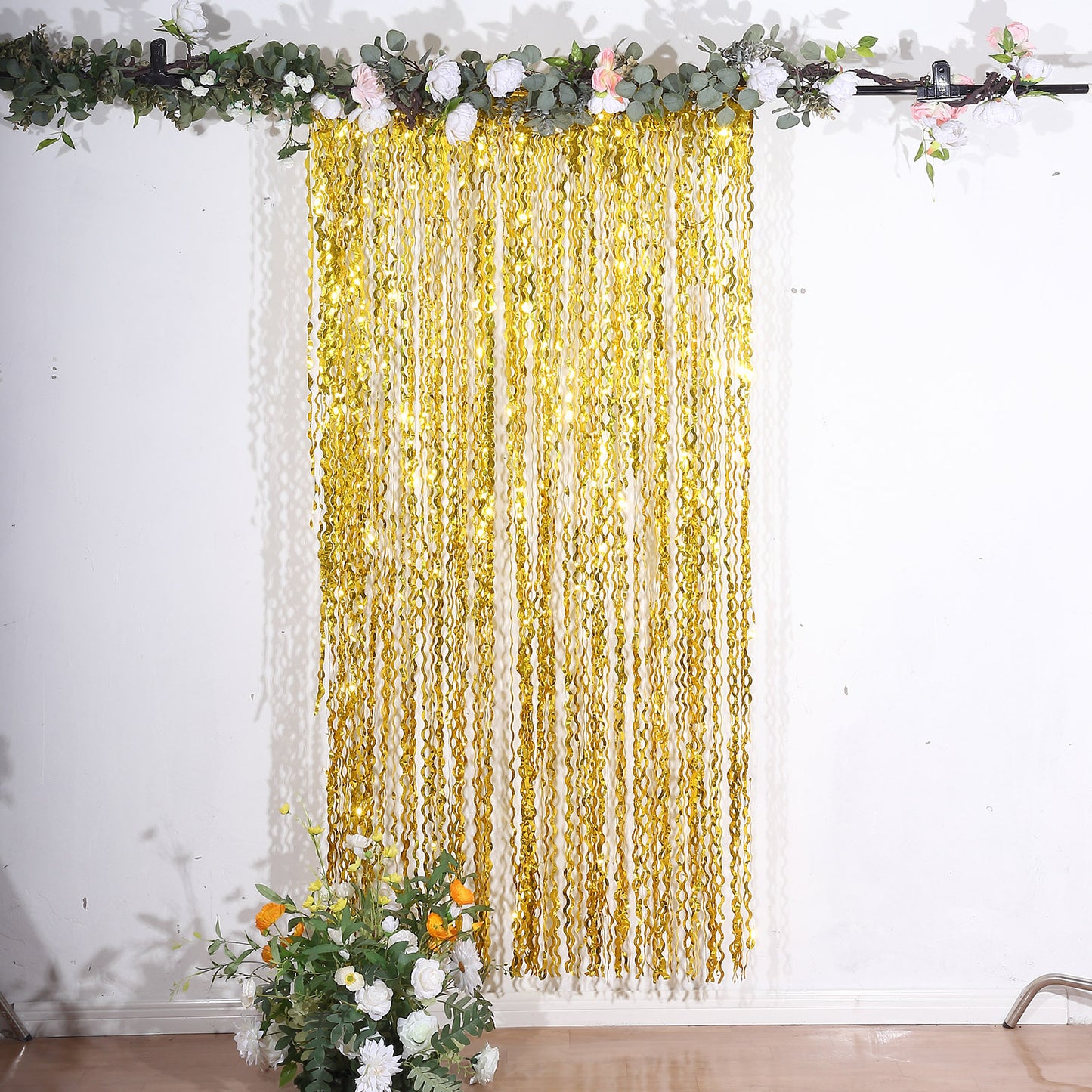 Metallic gold wavy foil fringe party backdrop curtain.