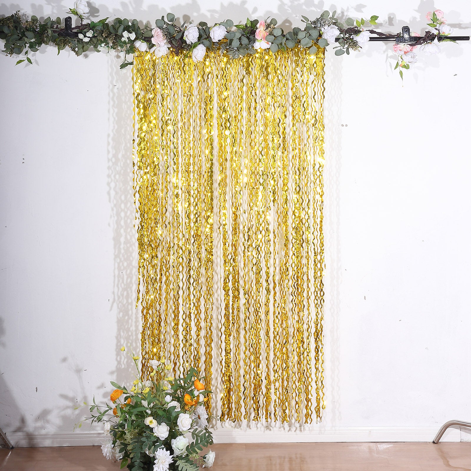 Metallic gold wavy foil fringe party backdrop curtain.