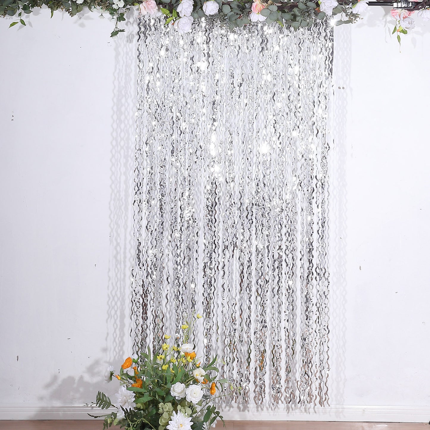 Metallic silver wavy foil fringe party backdrop curtain.