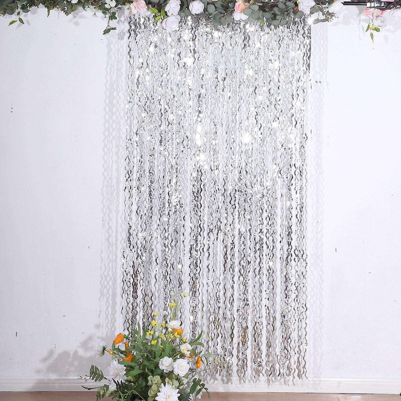 Metallic silver wavy foil fringe party backdrop curtain.
