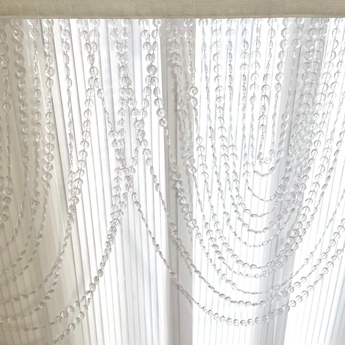 Clear acrylic crystal beaded curtain valance with polyester rod pocket.