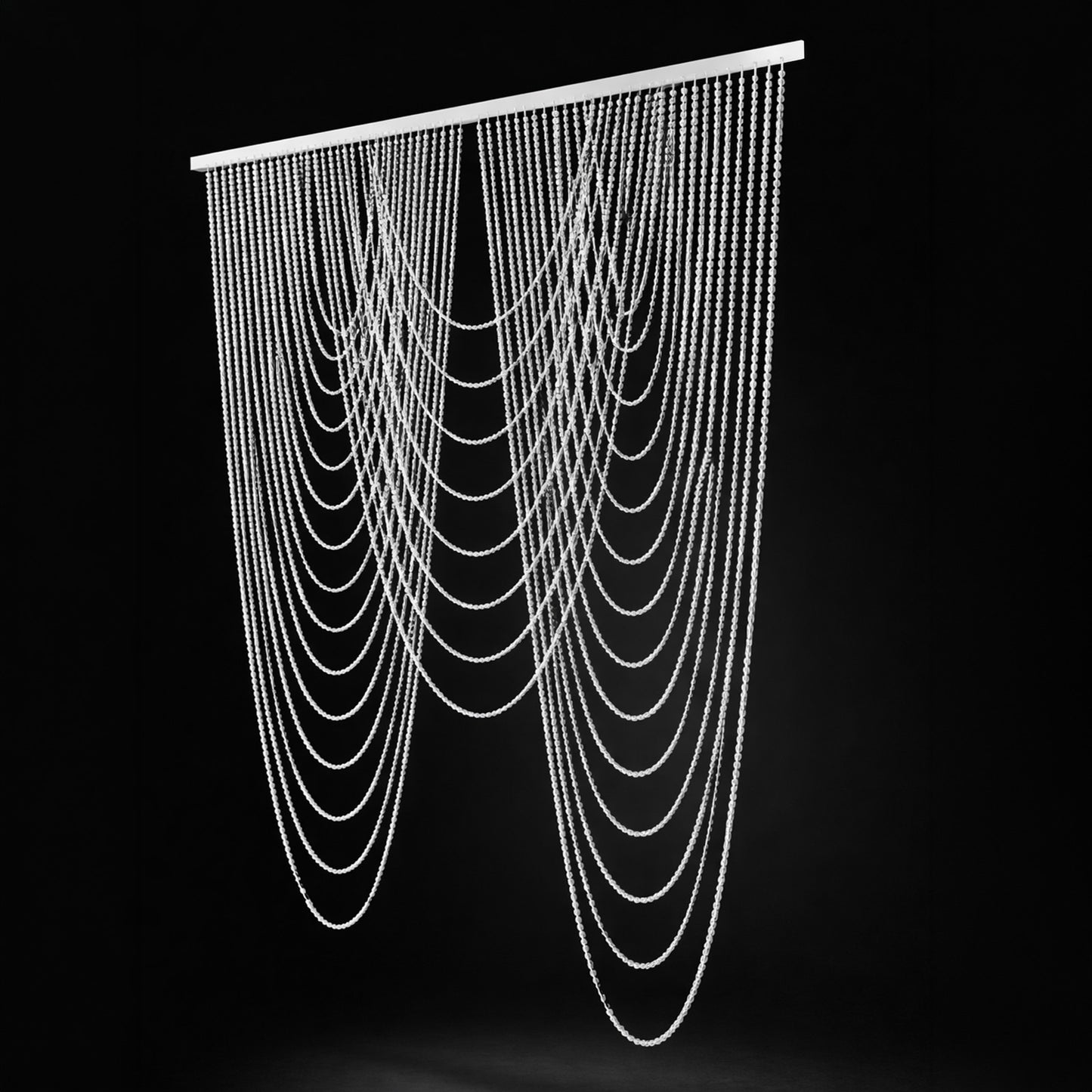 Clear acrylic beaded curtain in white, triple swag valance backdrop.