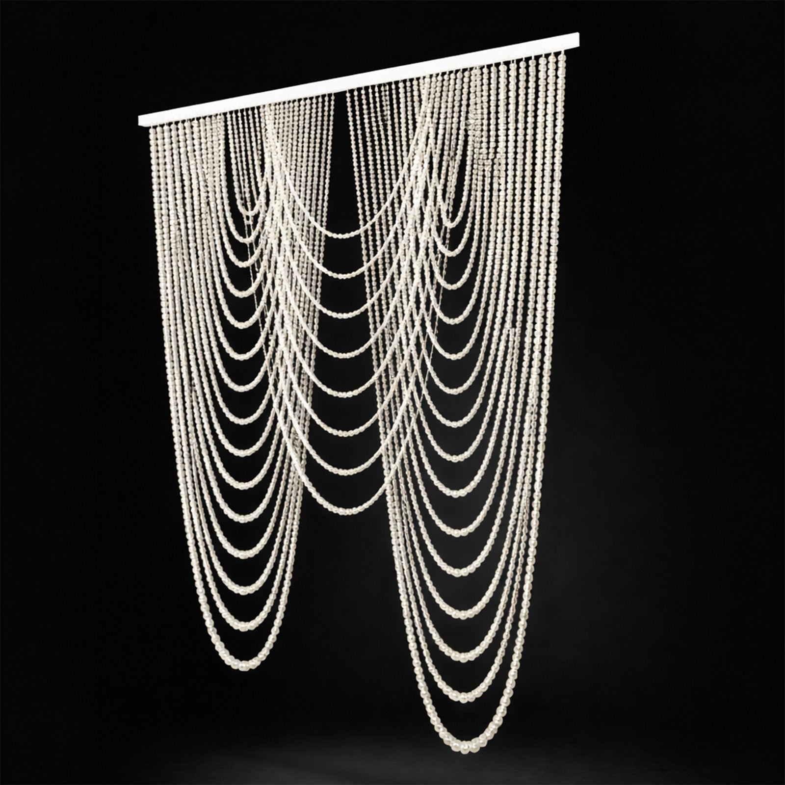 White faux pearl beaded curtain swag backdrop for doorway or wall decor.