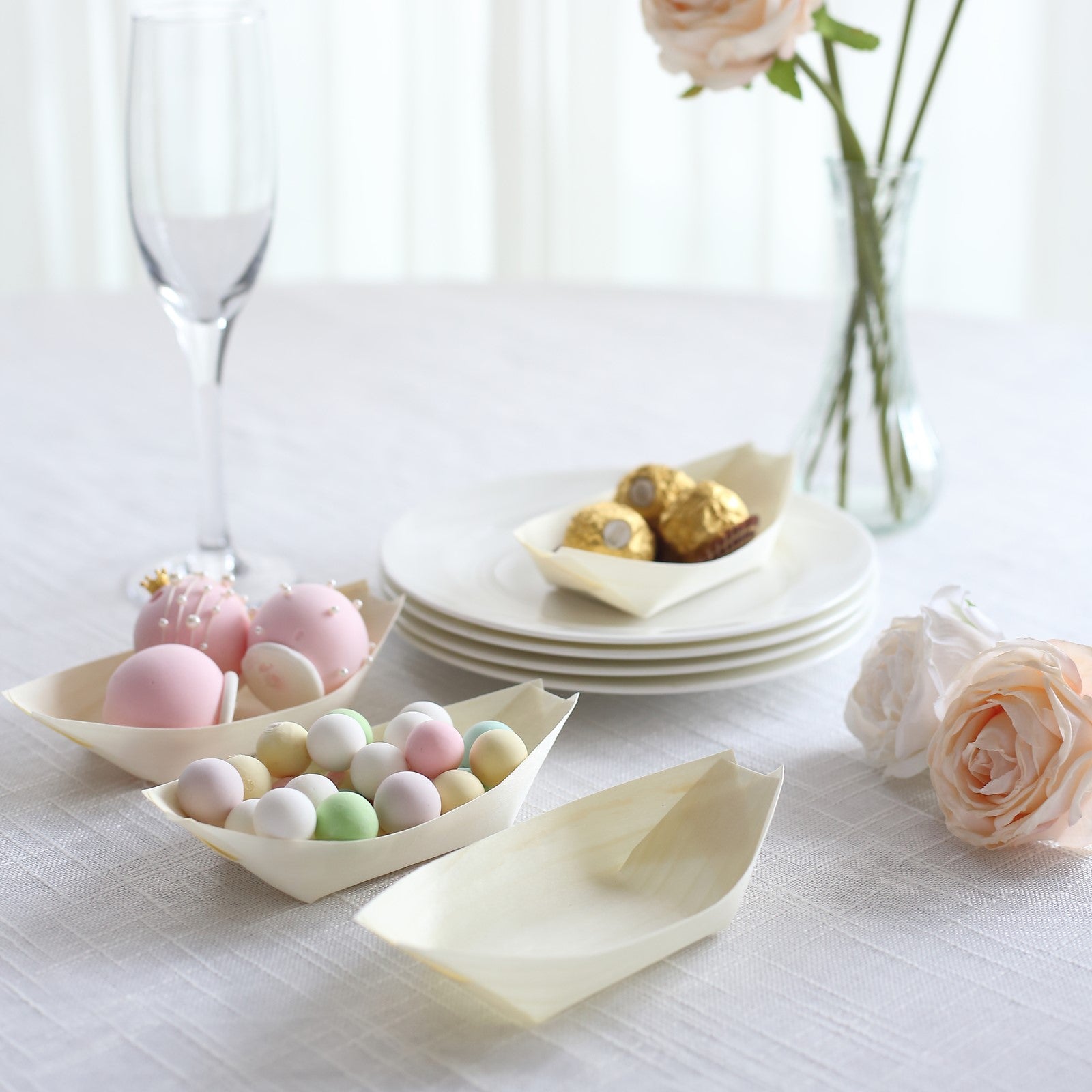 Natural biodegradable wooden boat-shaped plates for serving snacks and sushi.