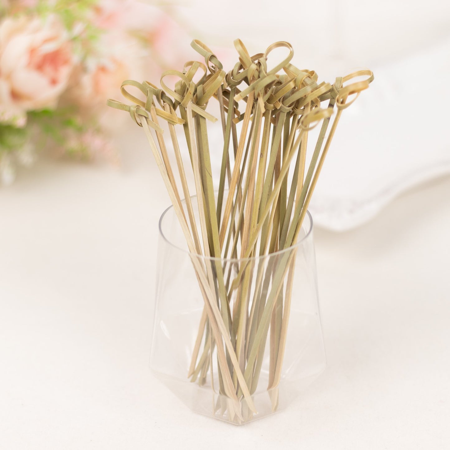 Eco-friendly twisted knot bamboo cocktail sticks in light brown color.