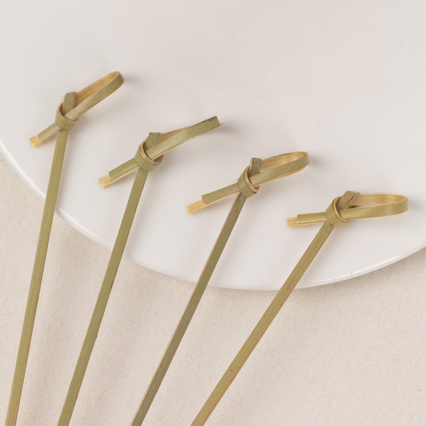 Eco-friendly twisted knot bamboo cocktail sticks for parties.