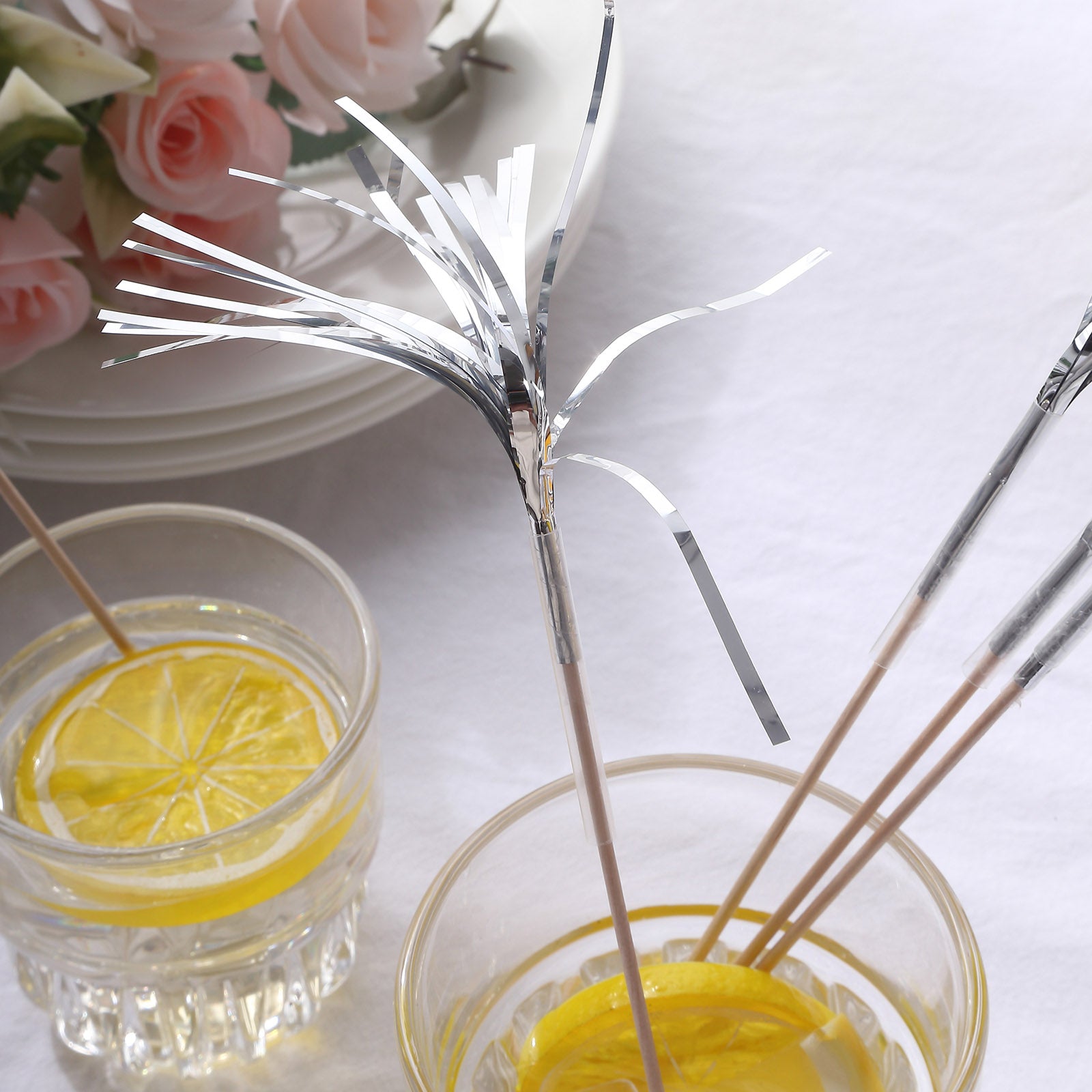 Silver firework frills cake toppers in drinks and plates setting.