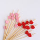 Red and pink eco-friendly bamboo heart skewers for cocktails and appetizers.