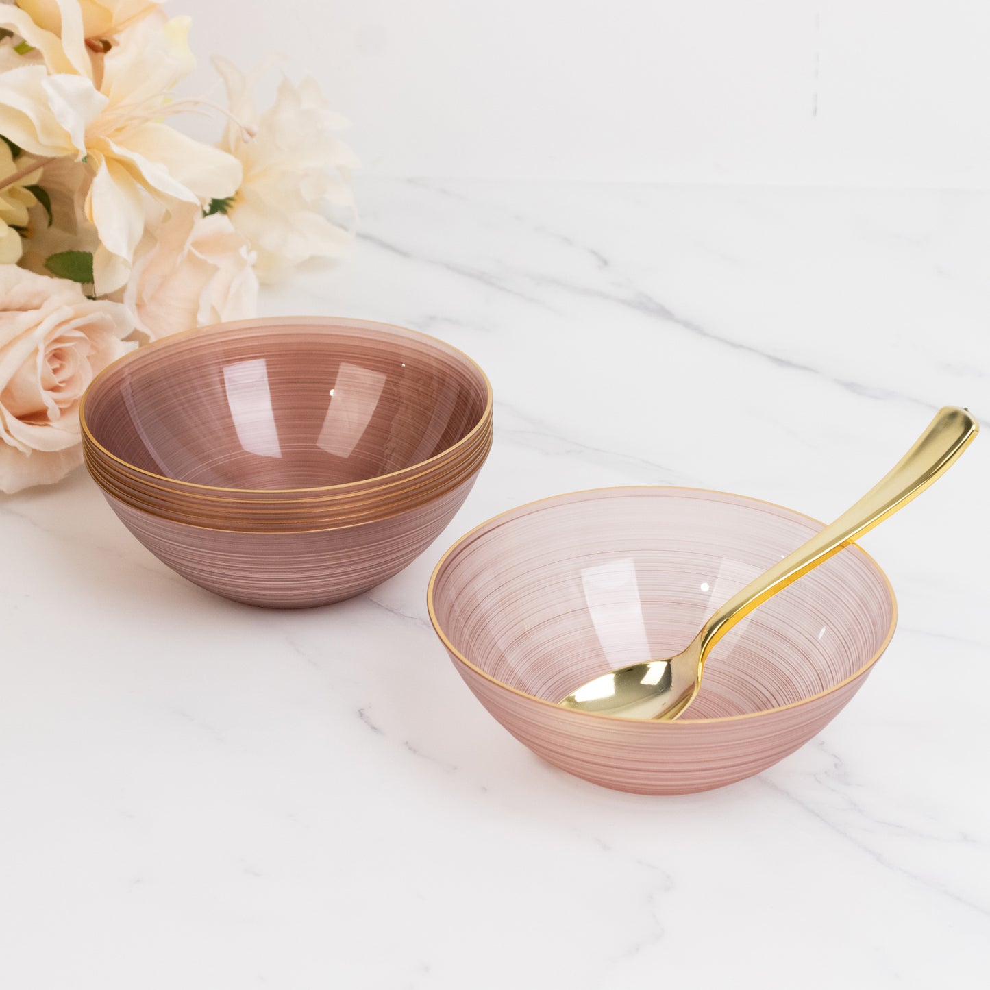 Transparent dusty rose bowls with gold rim, elegant crystal-like swirl design.