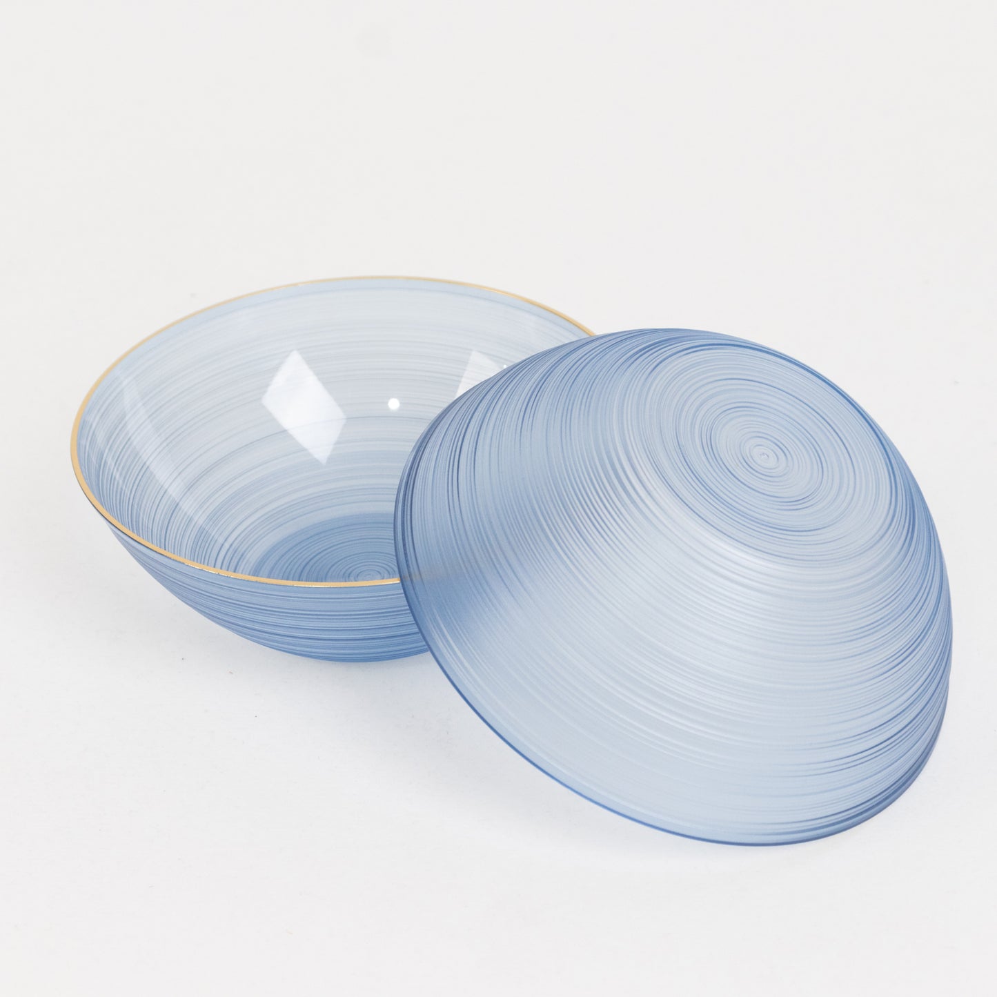 Transparent dusty blue plastic bowl with a gold rim, elegant swirl design.