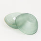 Transparent dusty sage green disposable bowl with gold rim.