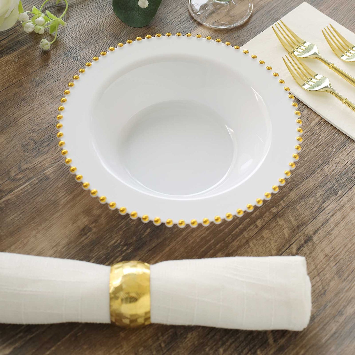 White round plastic dessert bowl with gold beaded rim.
