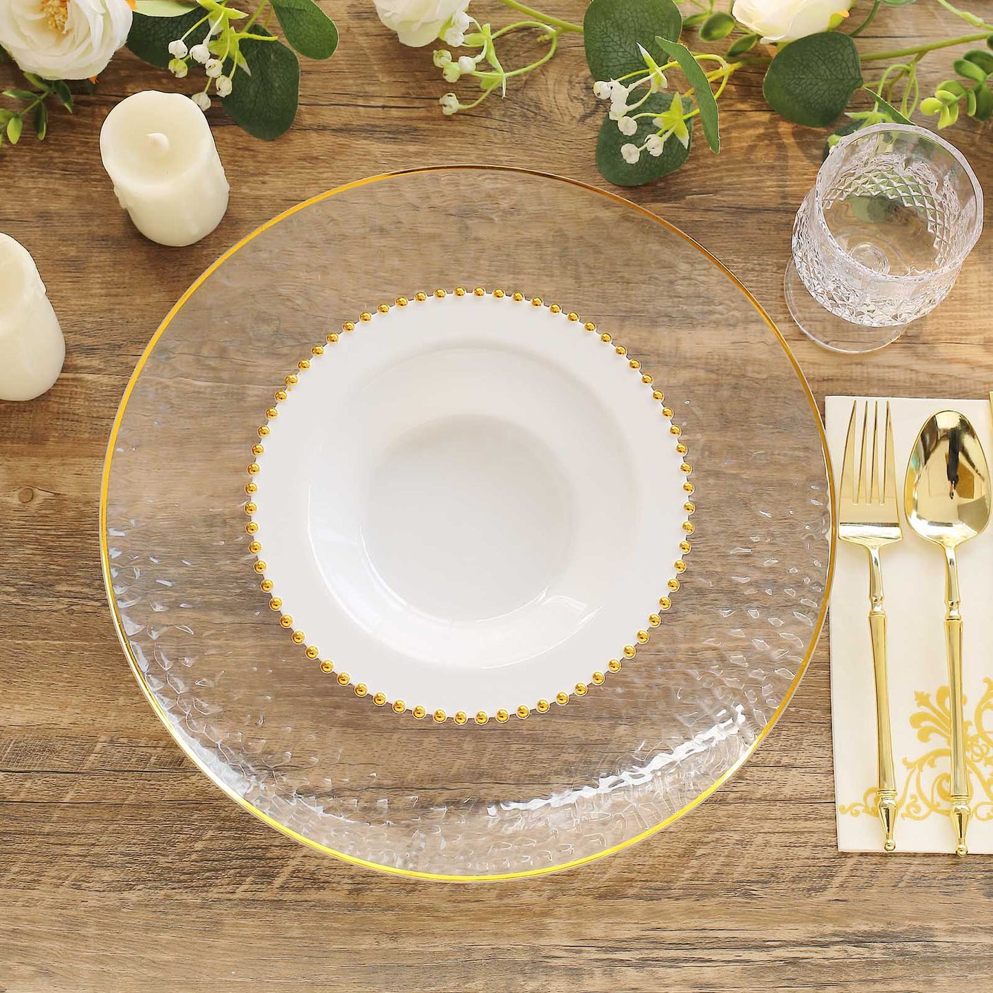 White round plastic dessert bowls with gold beaded rim on a table setting.