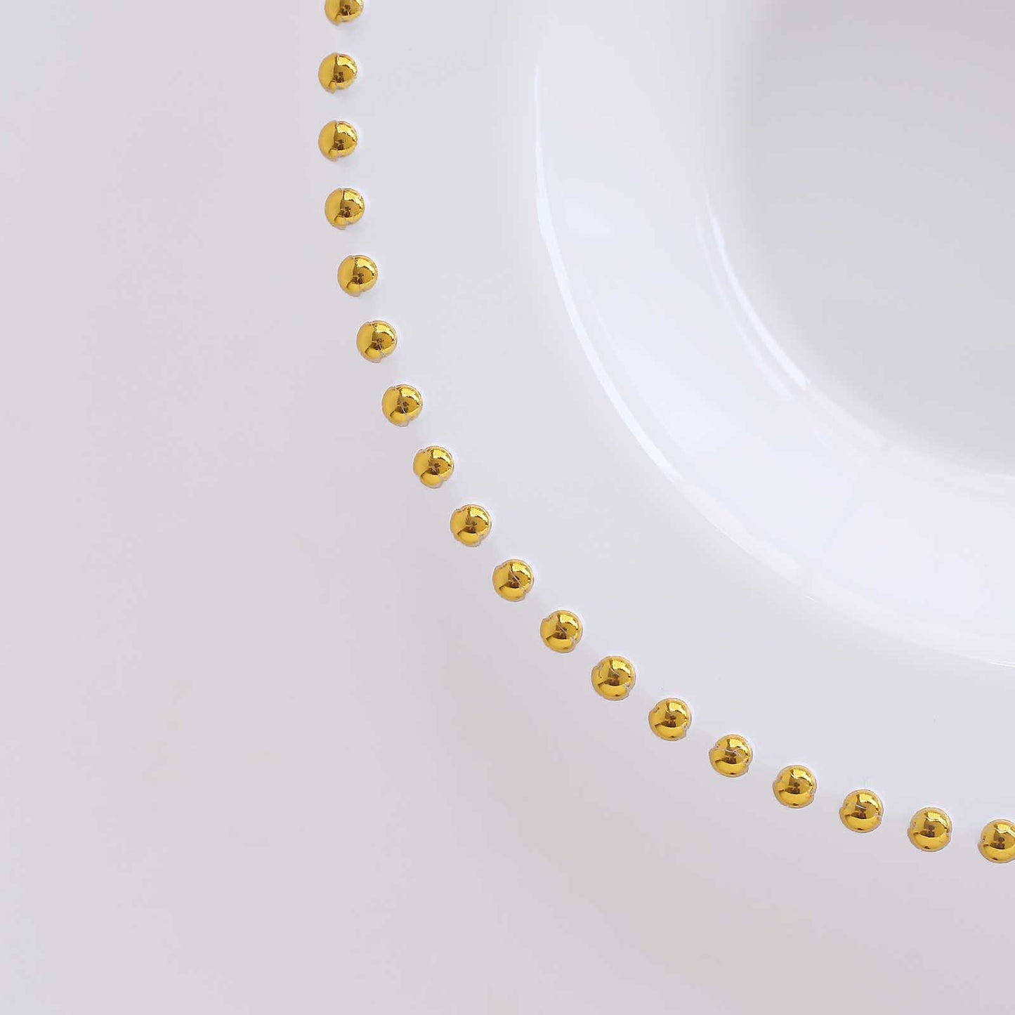 White round plastic dessert bowl with a gold beaded rim.