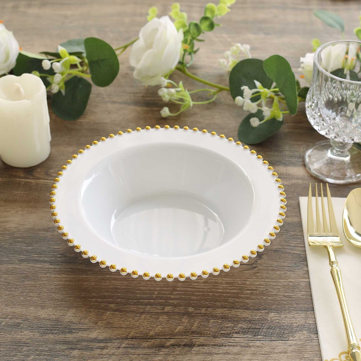 White round plastic dessert bowl with gold beaded rim.