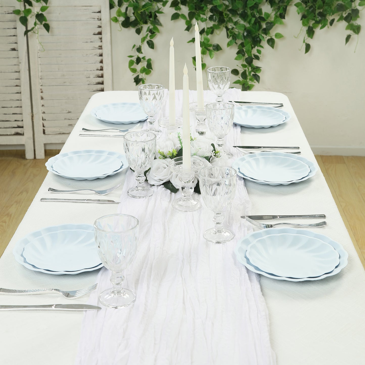 Light blue biodegradable salad plates on an elegant dining table setting.
