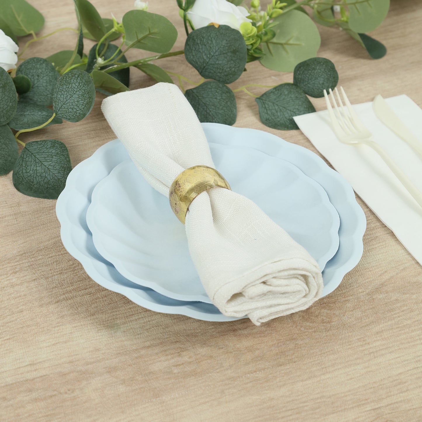 Light blue biodegradable salad plates with a scalloped edge and elegant table setting.