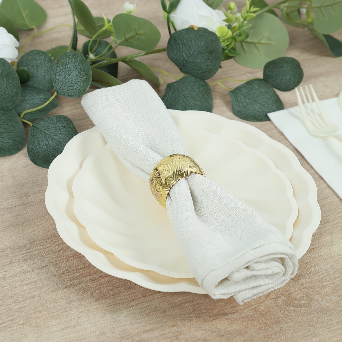 Cream biodegradable salad plates with a napkin, elegant disposable tableware.