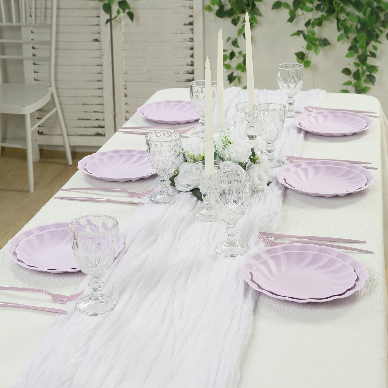 Lavender lilac biodegradable salad plates set on a table with floral decor.