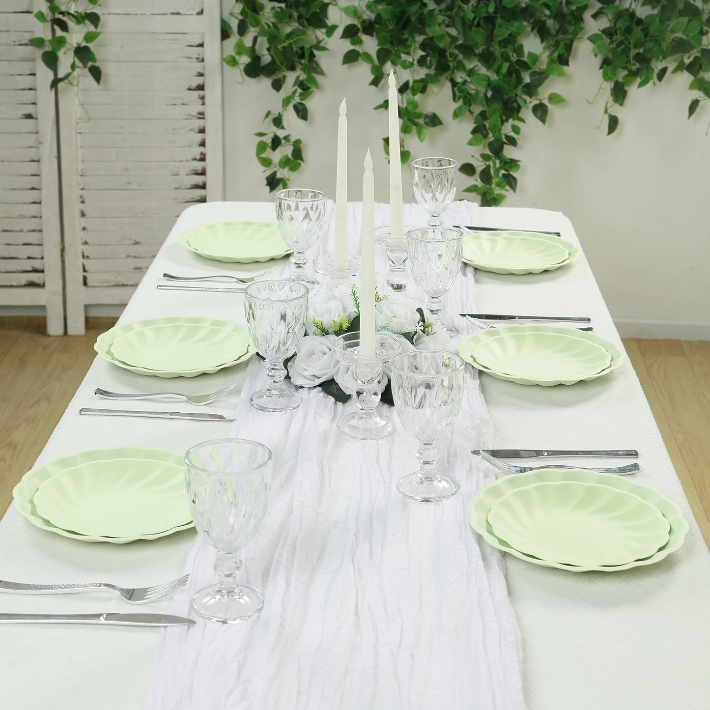 Sage green biodegradable salad plates set on an elegant dining table.