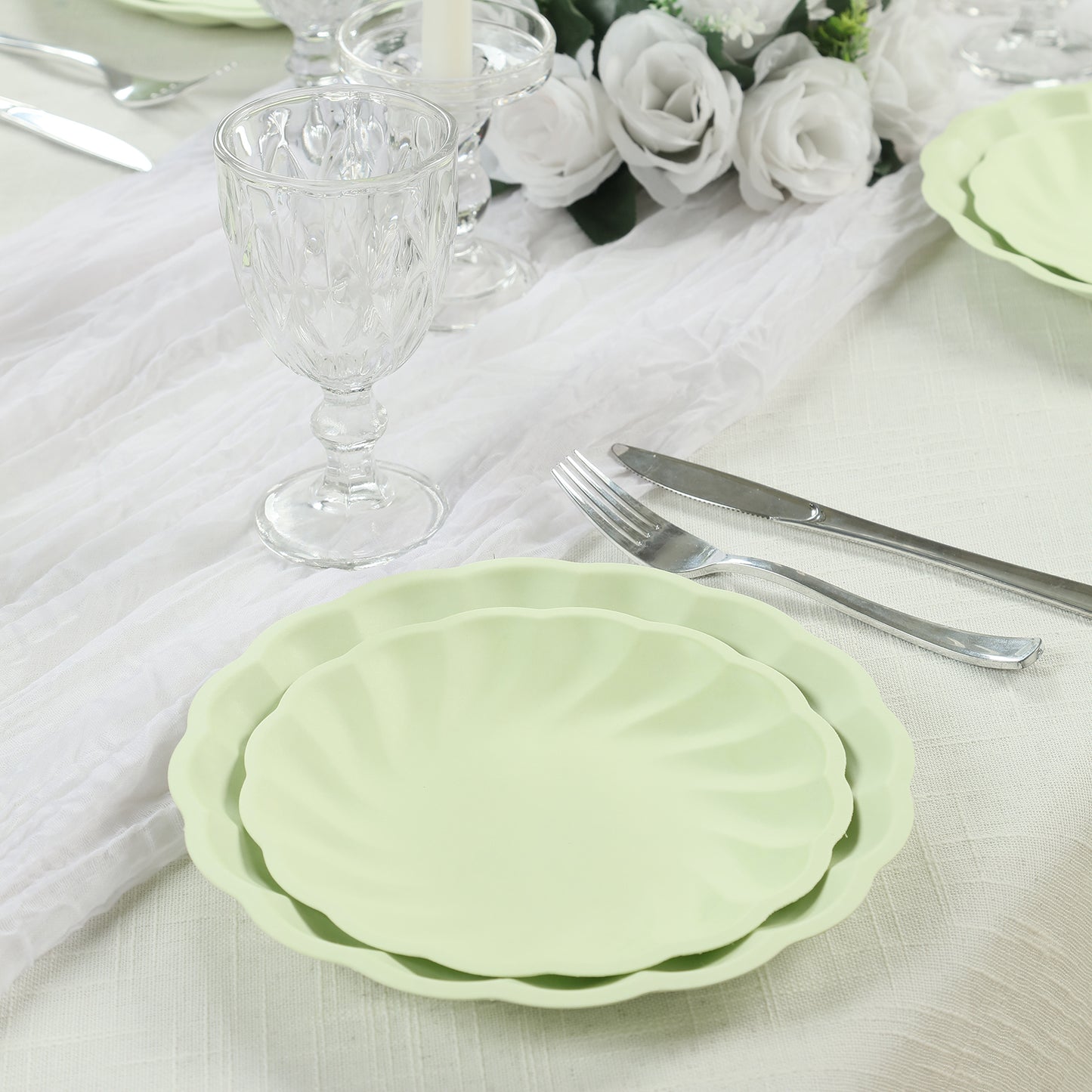 Sage green biodegradable salad plates with scalloped edges, elegant disposable tableware.
