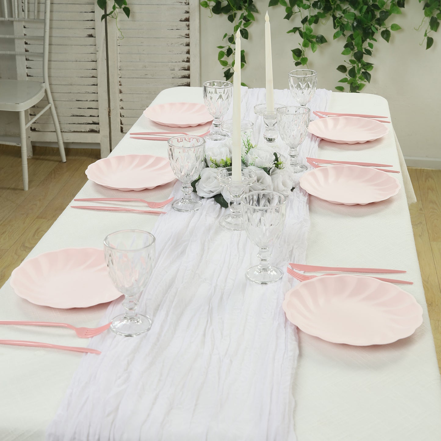 Blush biodegradable dinner plates set on an elegant dining table.