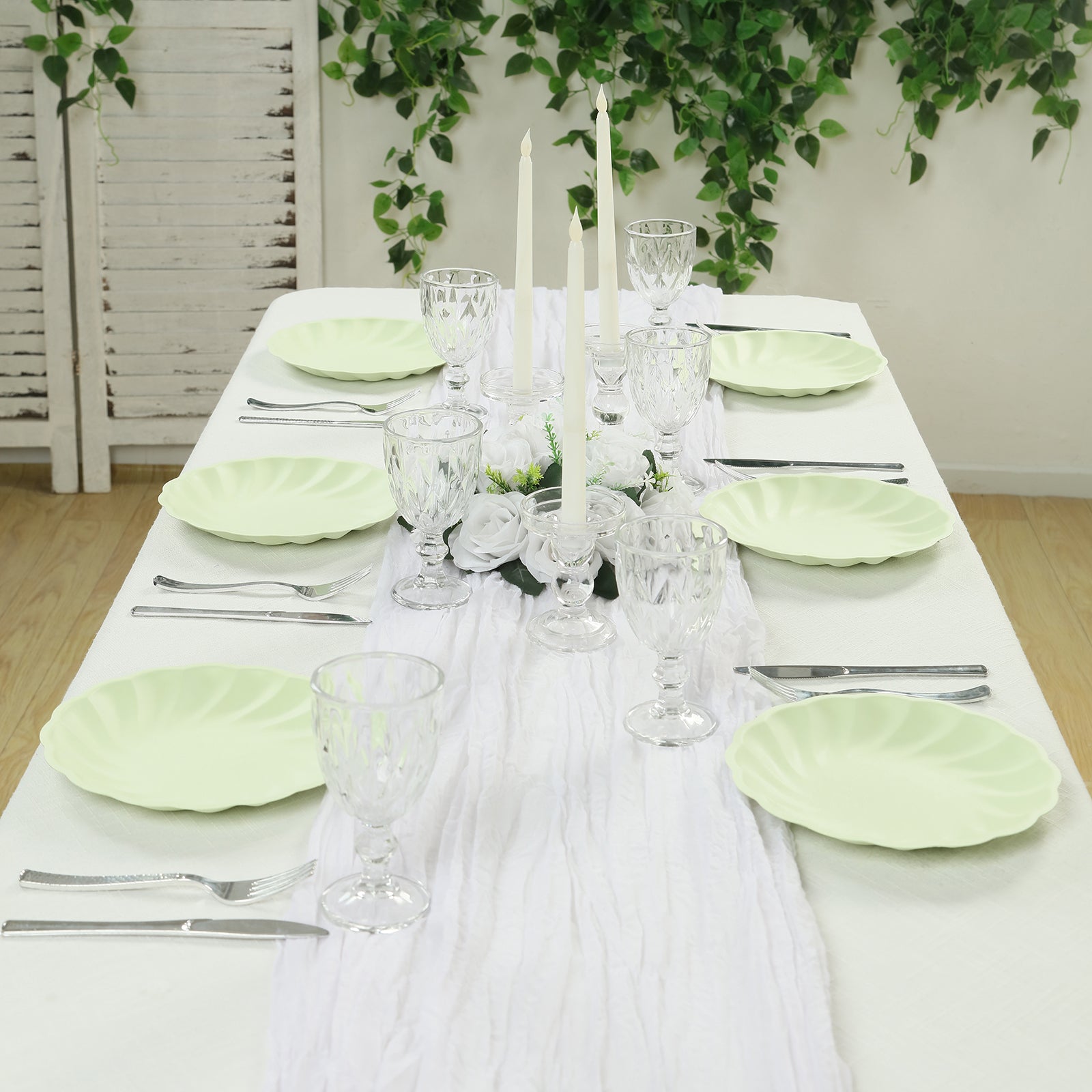 Sage green biodegradable dinner plates on a table setting.
