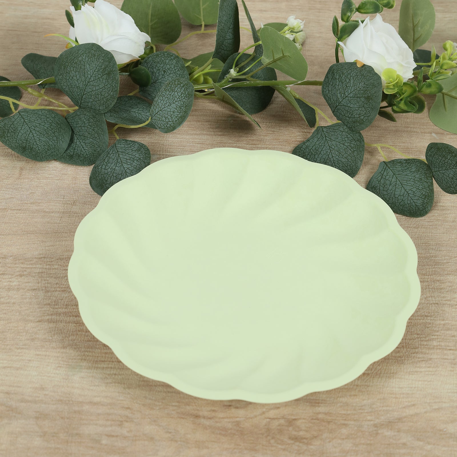 Sage green biodegradable dinner plate with swirl scalloped design.