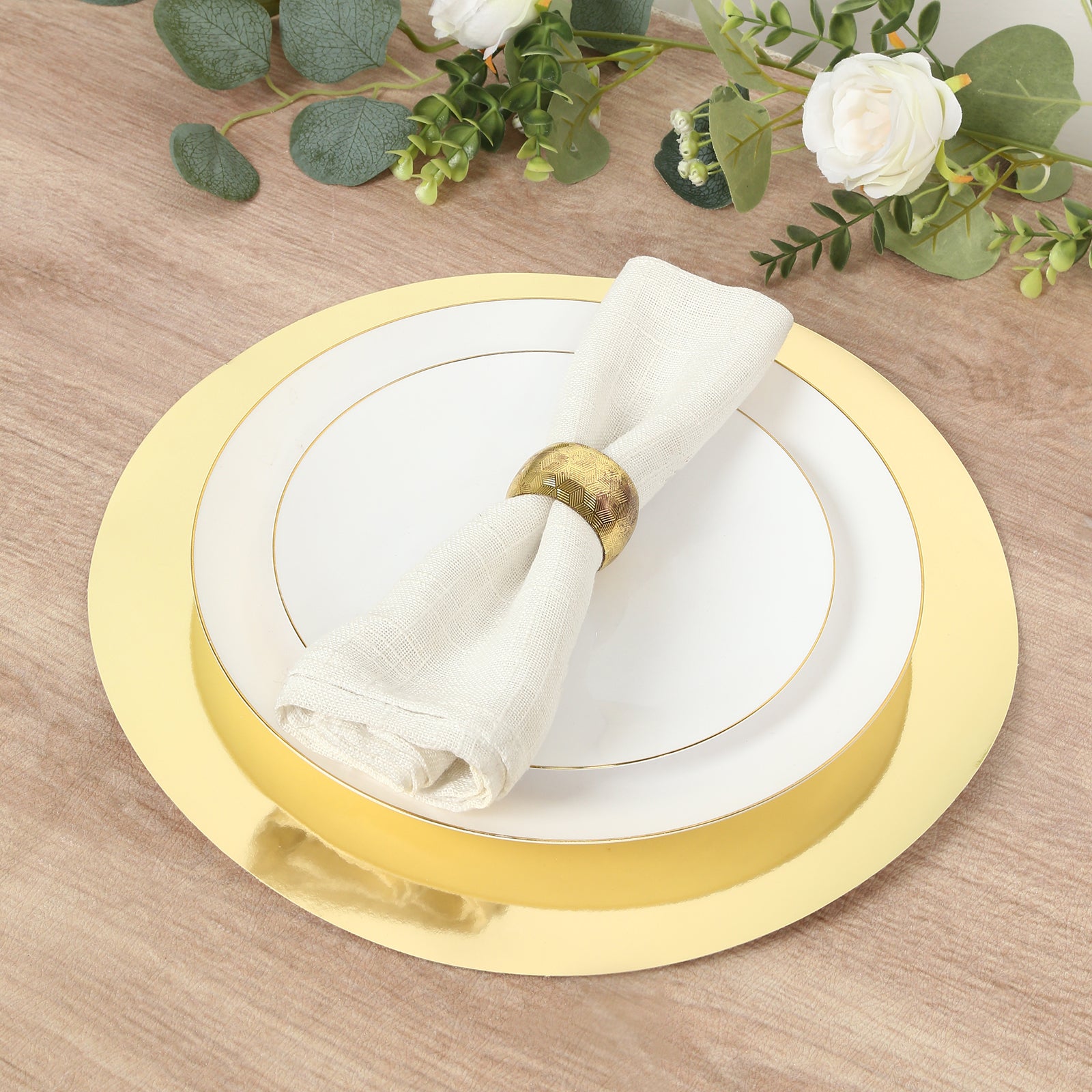 Gold round disposable table placemats with a white plate and napkin.