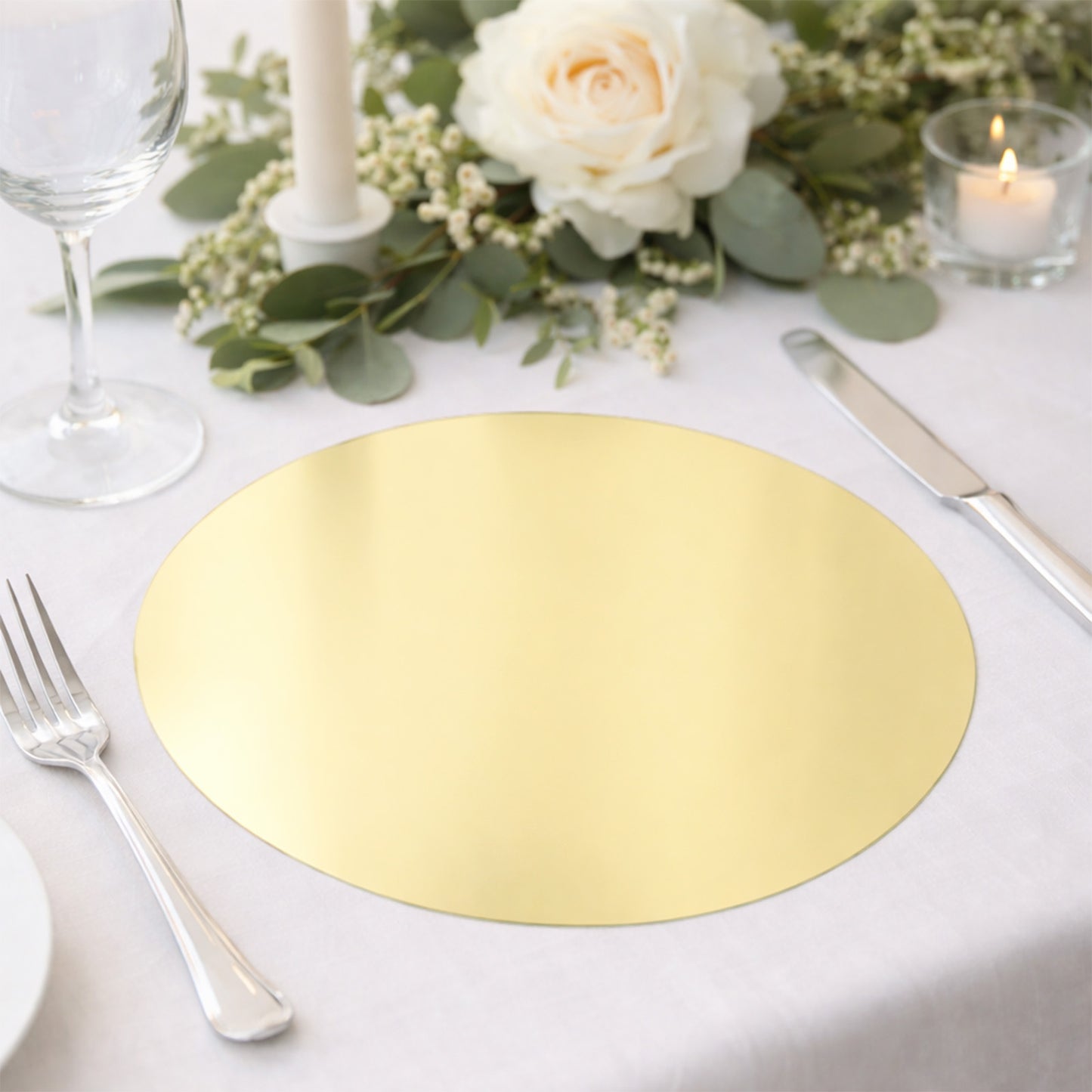 Gold round disposable table placemat on an elegantly set dining table.