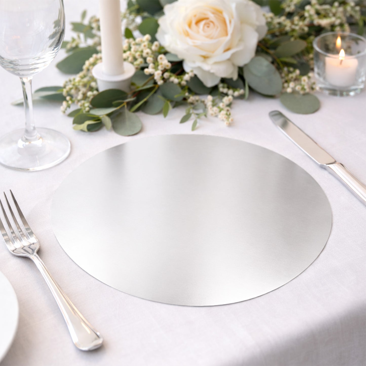 Silver round disposable table placemat for catering and special events.