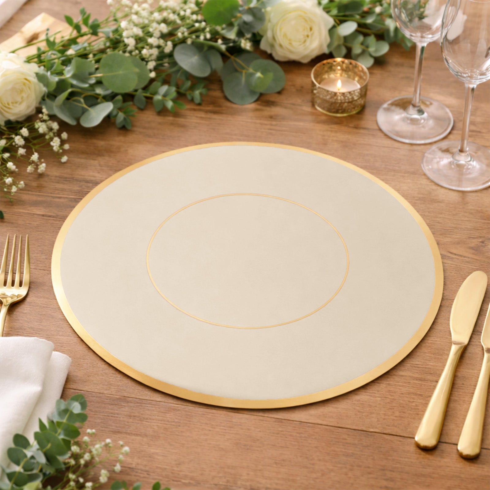 Taupe round disposable placemat with gold rim on a wooden table setting.