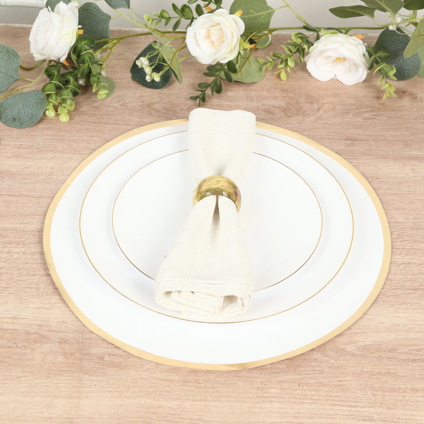 White round disposable placemat with gold rim on a wooden table.