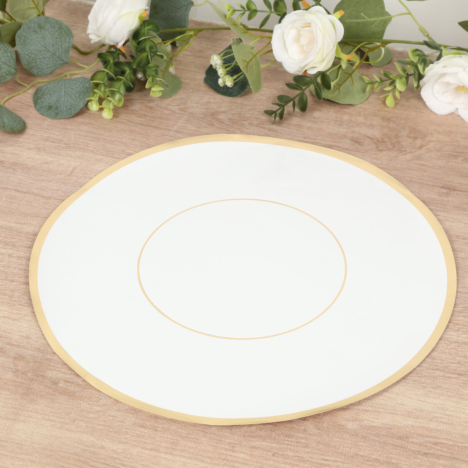White round disposable placemat with gold rim on a wooden surface.