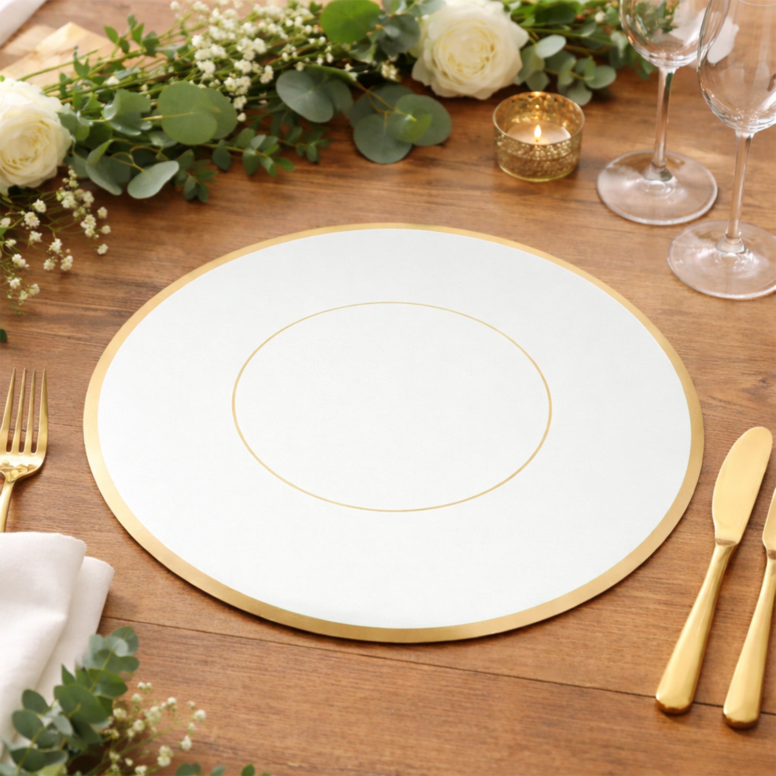 White round disposable placemat with gold rim on a wooden table setting.