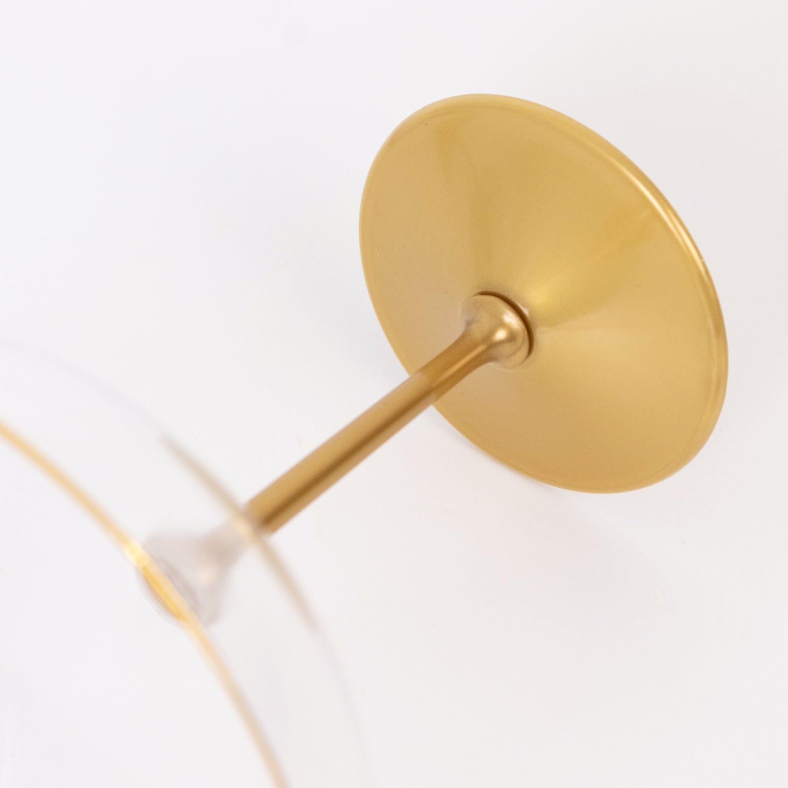 Clear glass wine glass with a gold stem and base
