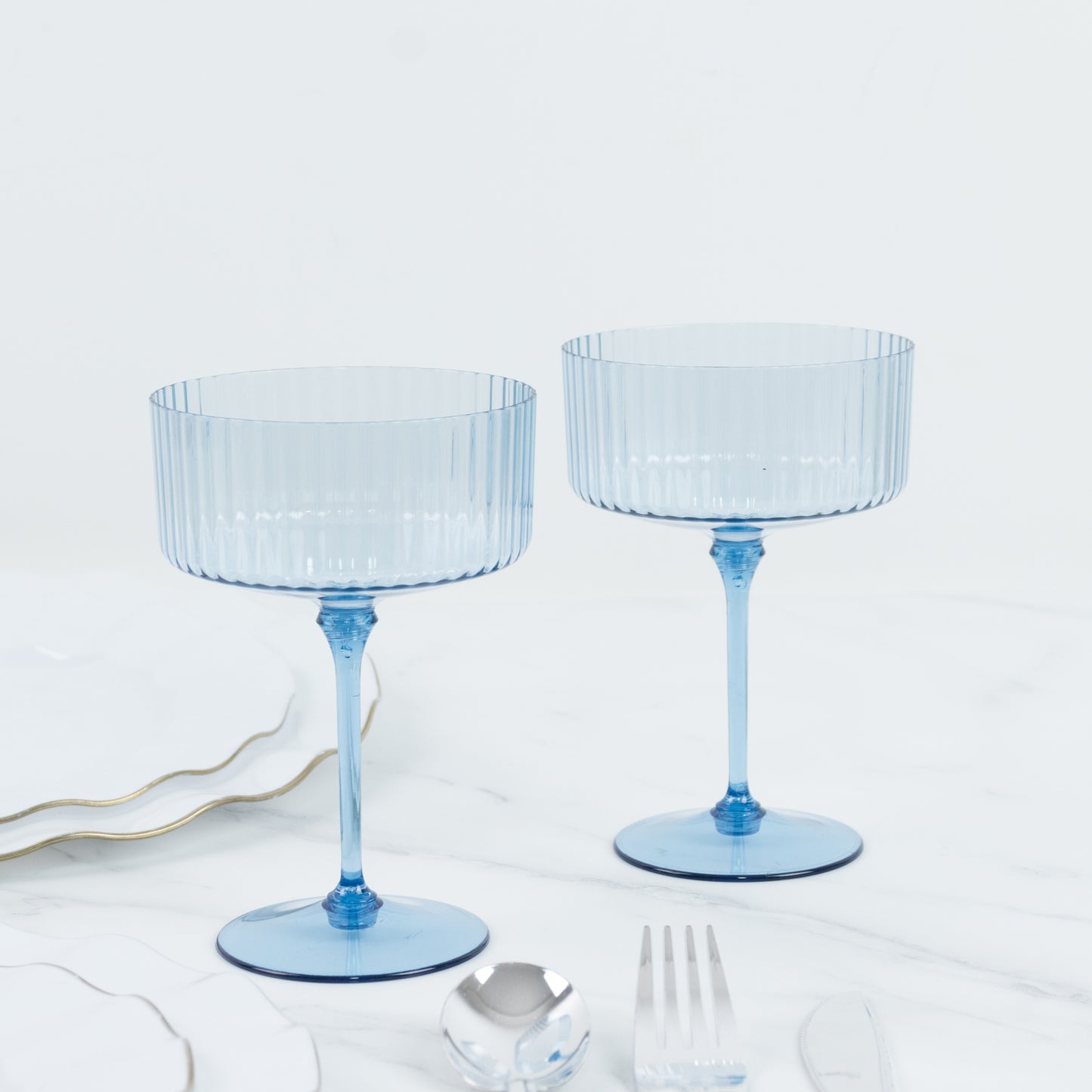 Dusty blue ribbed plastic cocktail glasses for parties and events.