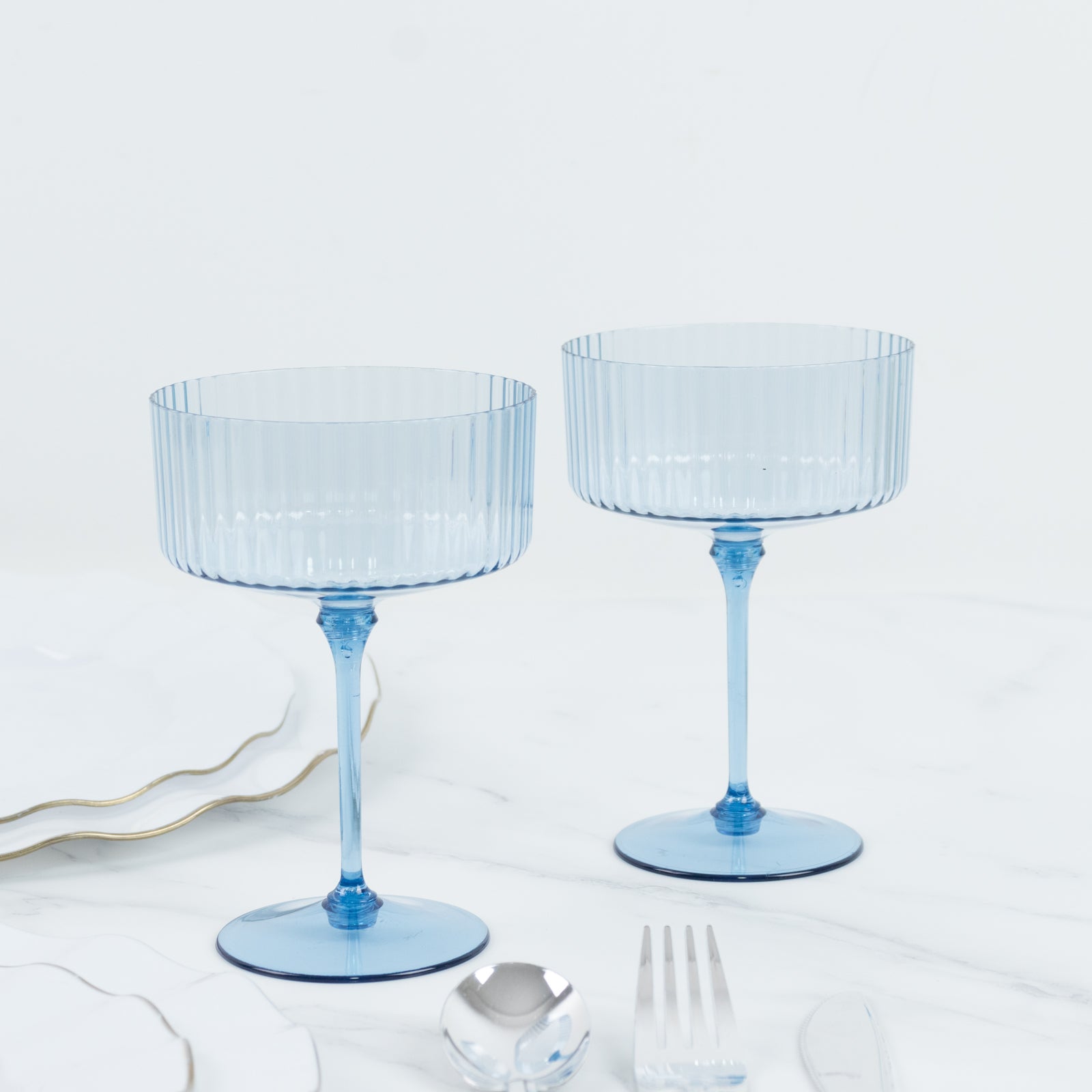 Dusty blue ribbed plastic cocktail glasses for parties and events.