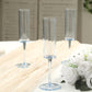 Transparent dusty blue reusable champagne flute glasses on a table.