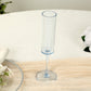 Transparent dusty blue champagne flute glass on a table setting.