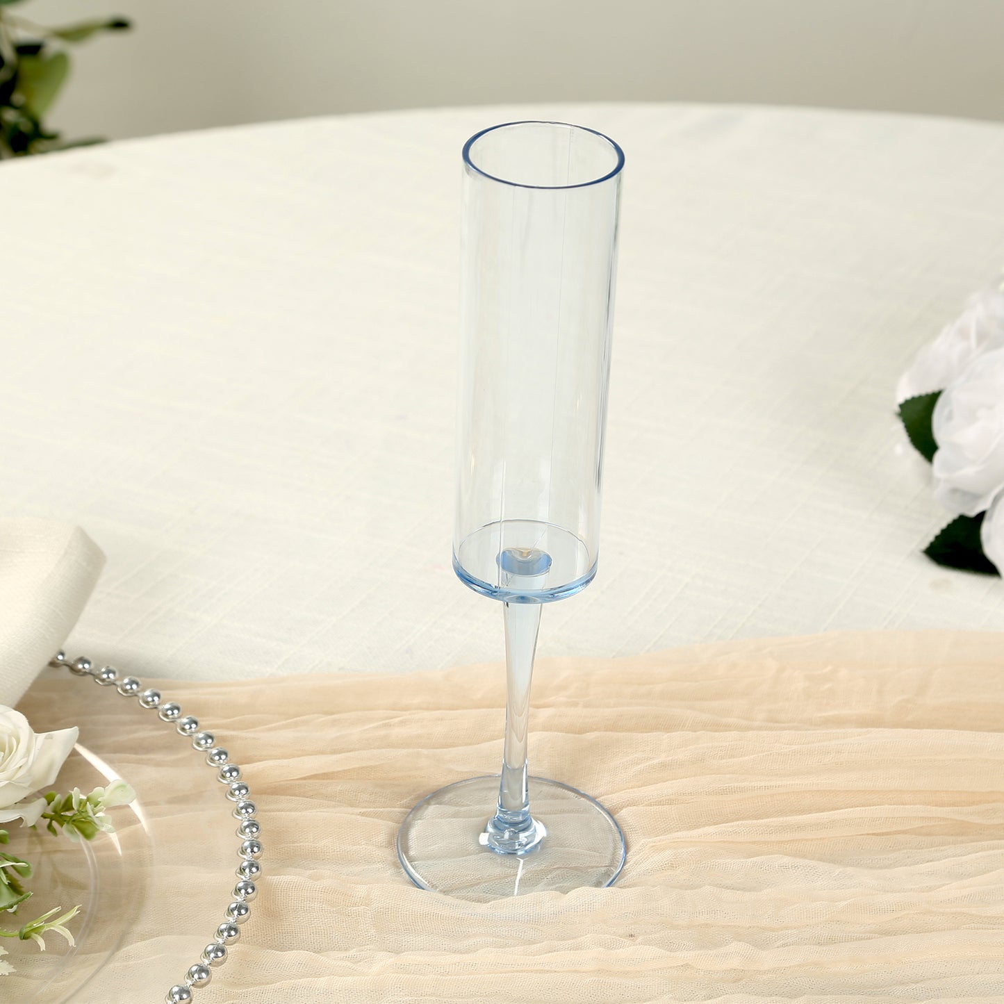 Transparent dusty blue champagne flute glass on a table setting.