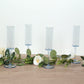Dusty blue reusable plastic champagne flute glasses with long stems.