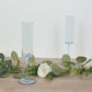 Transparent dusty blue champagne flute glasses with long stems.