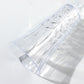 Clear reusable champagne flute with embossed leaf pattern.