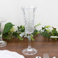 Clear shatterproof plastic champagne flute with embossed leaf pattern.