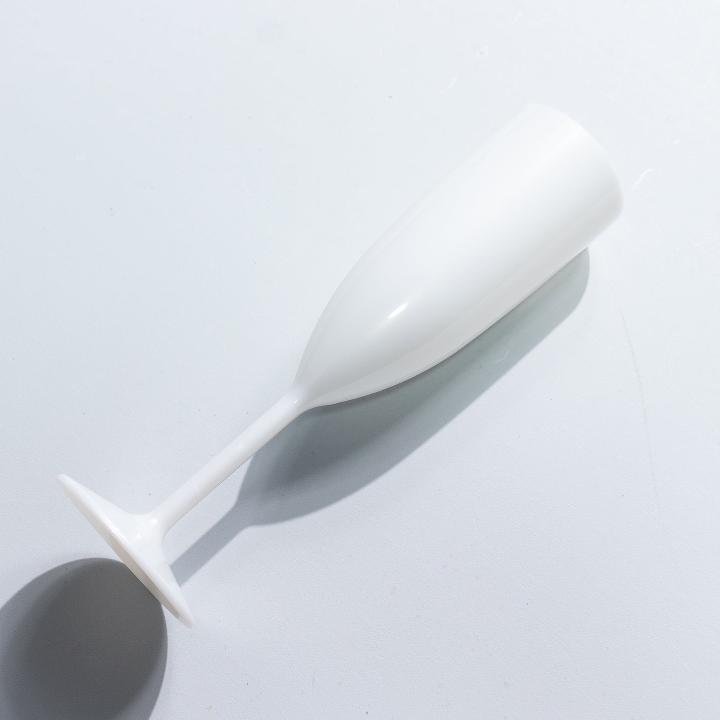 Pearl white shatterproof champagne flute for celebrations.