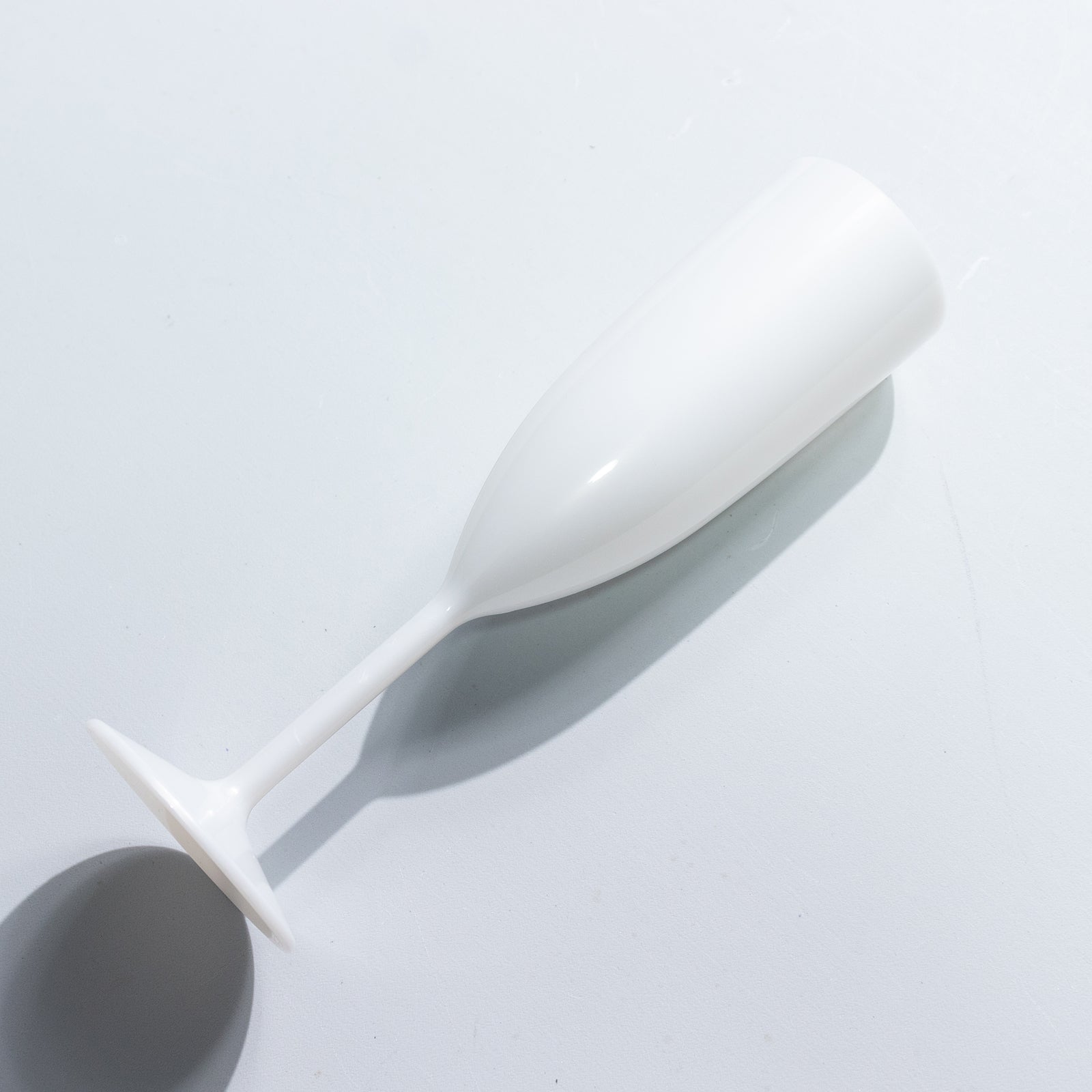 Pearl white shatterproof champagne flute for celebrations.